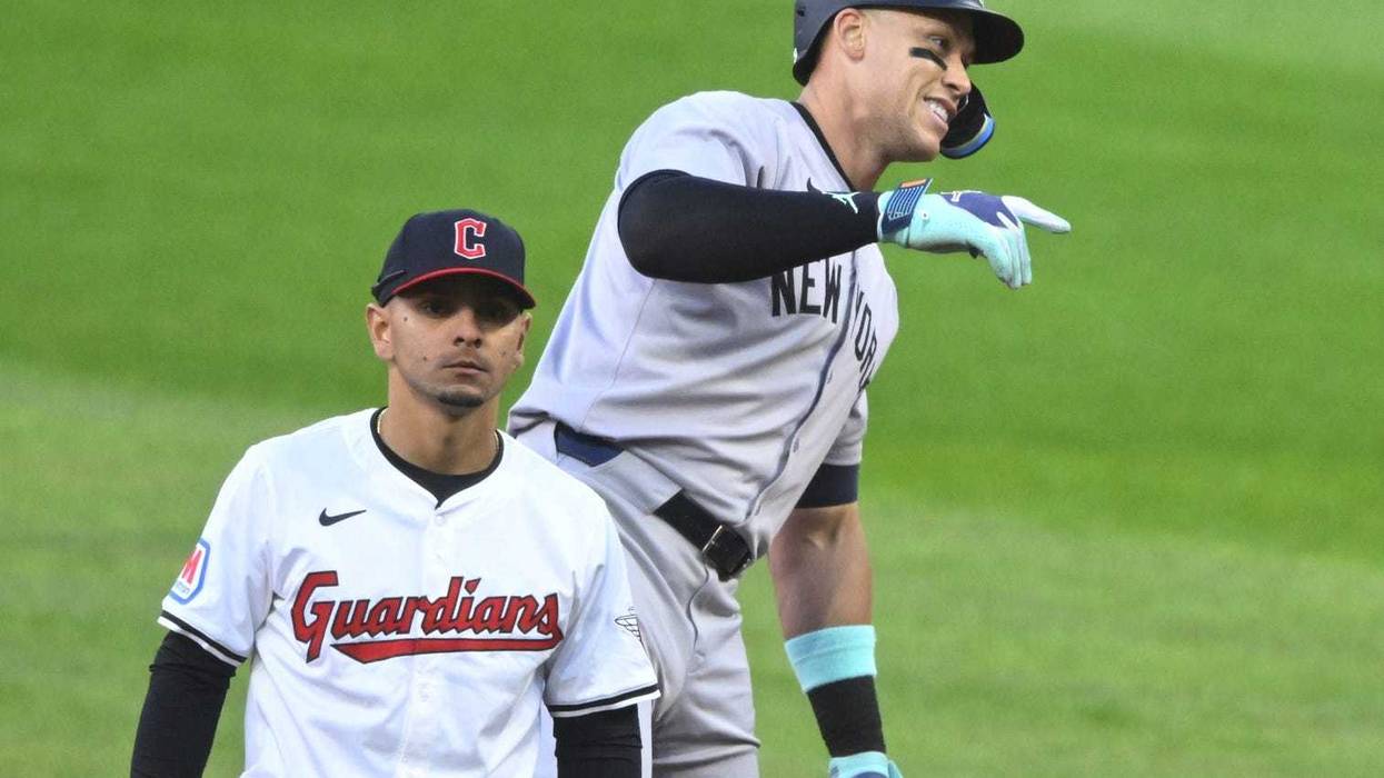 Apr 13, 2024; Cleveland, Ohio, USA; New York Yankees center fielder Aaron Judge (99) celebrates his double beside Cleveland Guardians second baseman Andres Gimenez (0) in the sixth inning at Progressive Field.