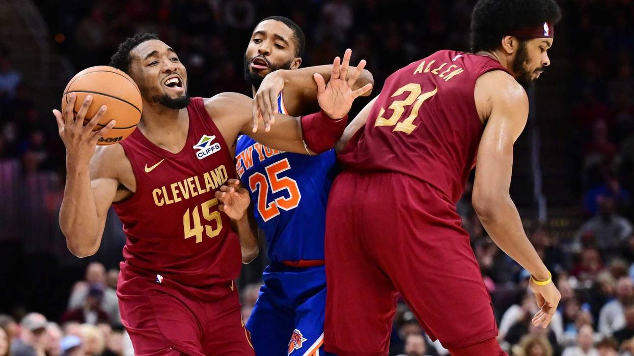 Apr 2, 2025; Cleveland, Ohio, USA; New York Knicks forward Mikal Bridges (25) fouls Cleveland Cavaliers guard Donovan Mitchell (45) as center Jarrett Allen (31) sets a pick during the second half at Rocket Arena.
