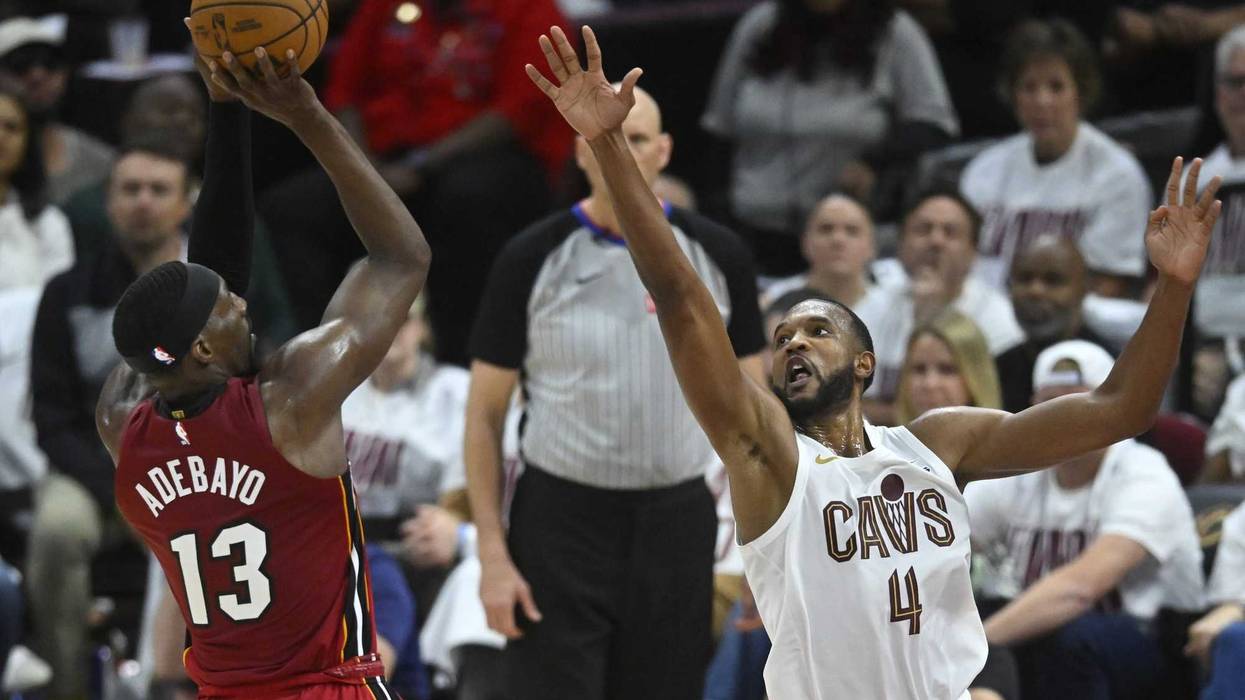 Apr 20, 2025; Cleveland, Ohio, USA; Miami Heat center Bam Adebayo (13) shoots beside Cleveland Cavaliers forward Evan Mobley (4) in the fourth quarter at Rocket Arena.
