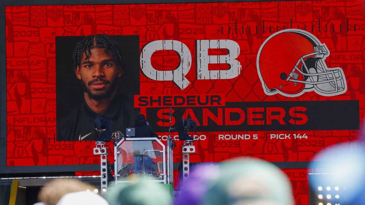 Apr 25, 2025; Green Bay, WI, USA; A graphic announcing Colorado quarterback Shedeur Sanders’ selection by the Cleveland Browns with the 144th overall pick is seen in the Draft Theater during the third day of the 2025 NFL Draft at Lambeau Field.