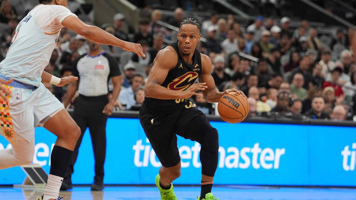 Apr 4, 2025; San Antonio, Texas, USA; Cleveland Cavaliers forward Isaac Okoro (35) dribbles against San Antonio Spurs forward Keldon Johnson (0) in the first half at Frost Bank Center.