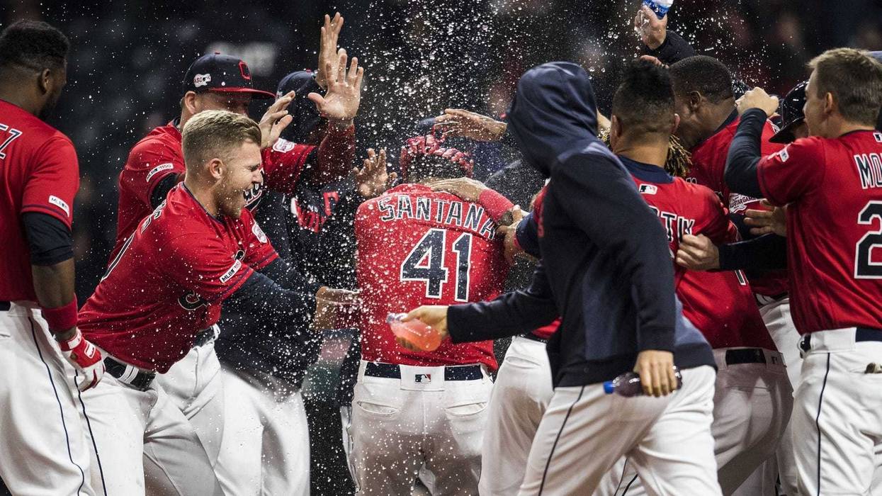 Apr 5, 2019; Cleveland, OH, USA; Cleveland Indians first baseman Carlos Santana (41) is mobbed by teammates after hitting a walk-off home run during the ninth inning against the Toronto Blue Jays at Progressive Field. Mandatory Credit: Ken Blaze-USA TODAY