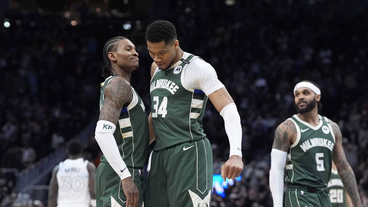 Apr 8, 2025; Milwaukee, Wisconsin, USA; Milwaukee Bucks guard Kevin Porter Jr. (3) and Milwaukee Bucks forward Giannis Antetokounmpo (34) celebrate as the clock winds down in their 110-103 comeback victory over the Minnesota Timberwolves at Fiserv Forum. Mandatory Credit: Michael McLoone-Imagn Images