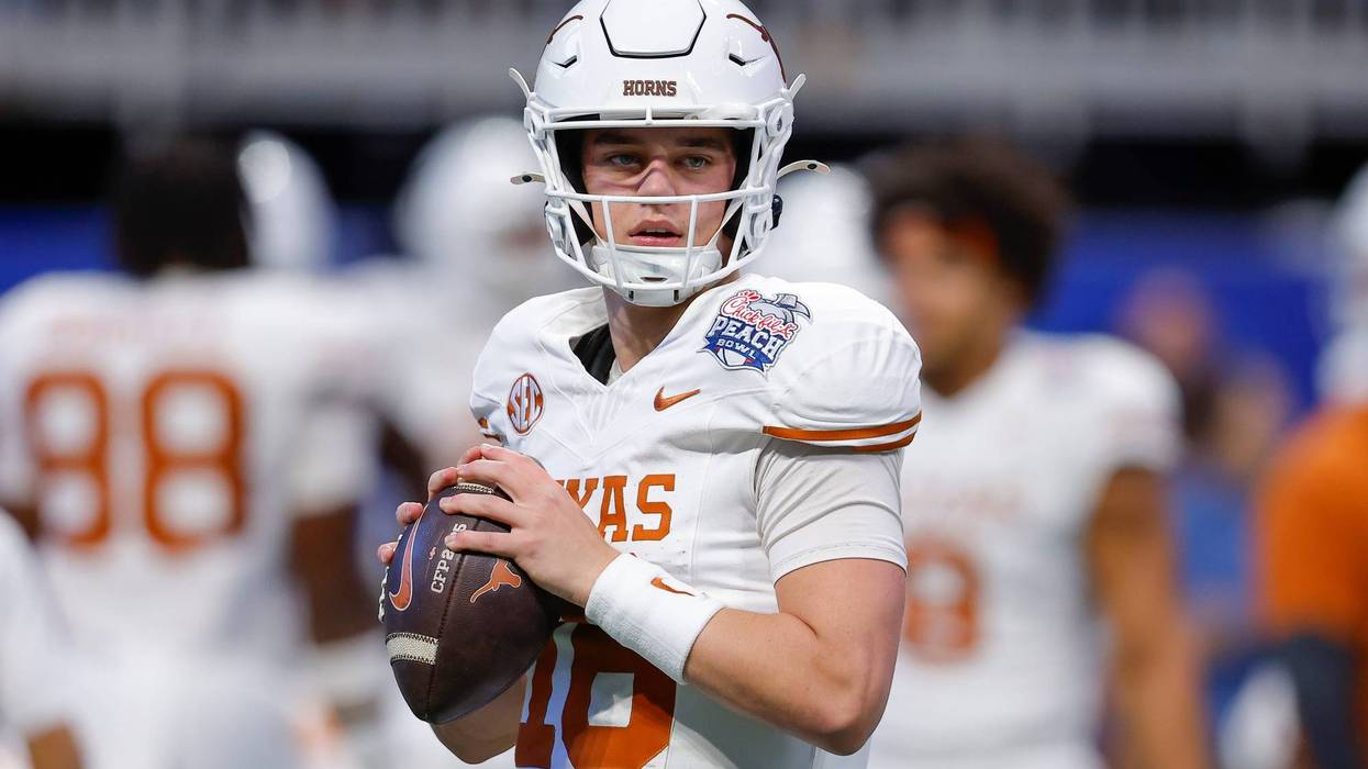 Arch Manning #16 of the Texas Longhorns warms up prior to the Chick-fil-A Peach Bowl between the Texas Longhorns and Arizona State Sun Devils at Mercedes-Benz Stadium on January 1, 2025, in Atlanta, Georgia.