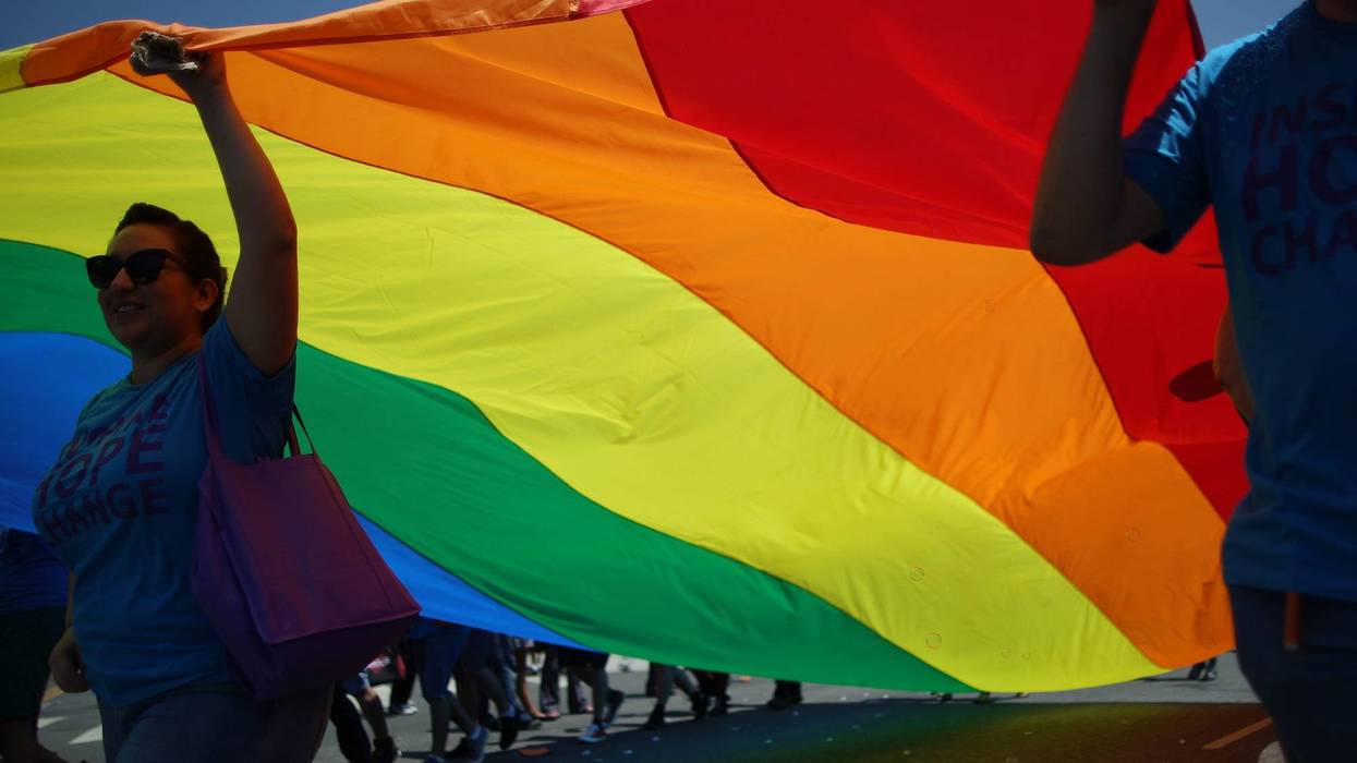 archers carry a rainbow flag in the LA Pride Parade on June 8, 2014 in West Hollywood, California.