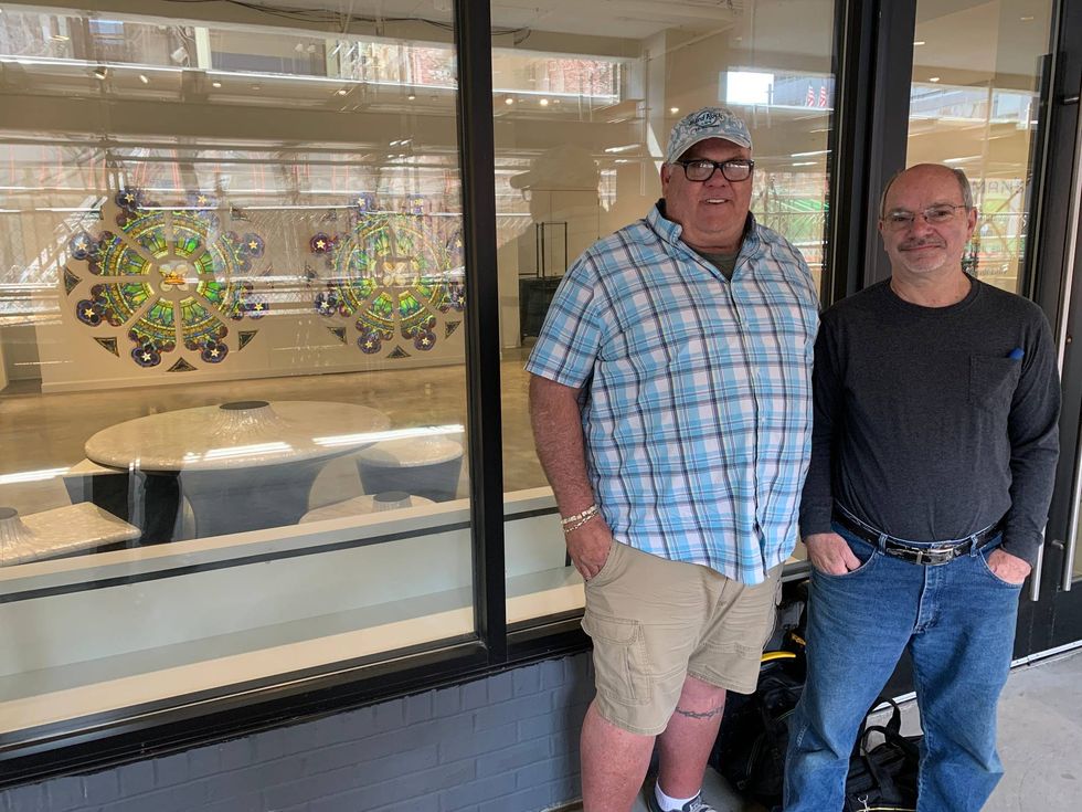 Architectural salvage man Paul Brown (left) with restorer Bob Ray (right) standing in front of the Tiffany stained glass windows