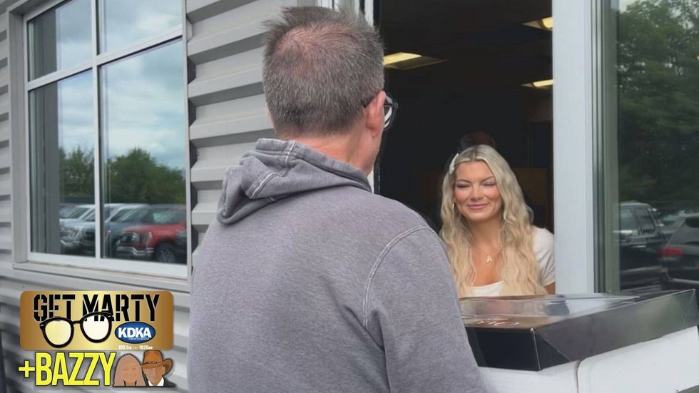 Arianna Bazzy greets Marty Griffin at the door to deliver her dad