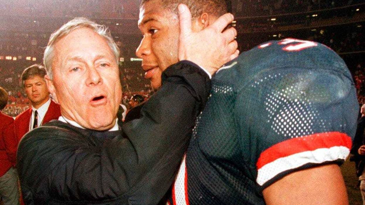 Arizona coach Dick Tomey, left, congratulates linebacker DaShon Polk after the Wildcats 23-20 win over Nebraska in the Holiday Bowl NCAA college football game in San Diego. Tomey, the winningest football coach in University of Arizona history, died Friday