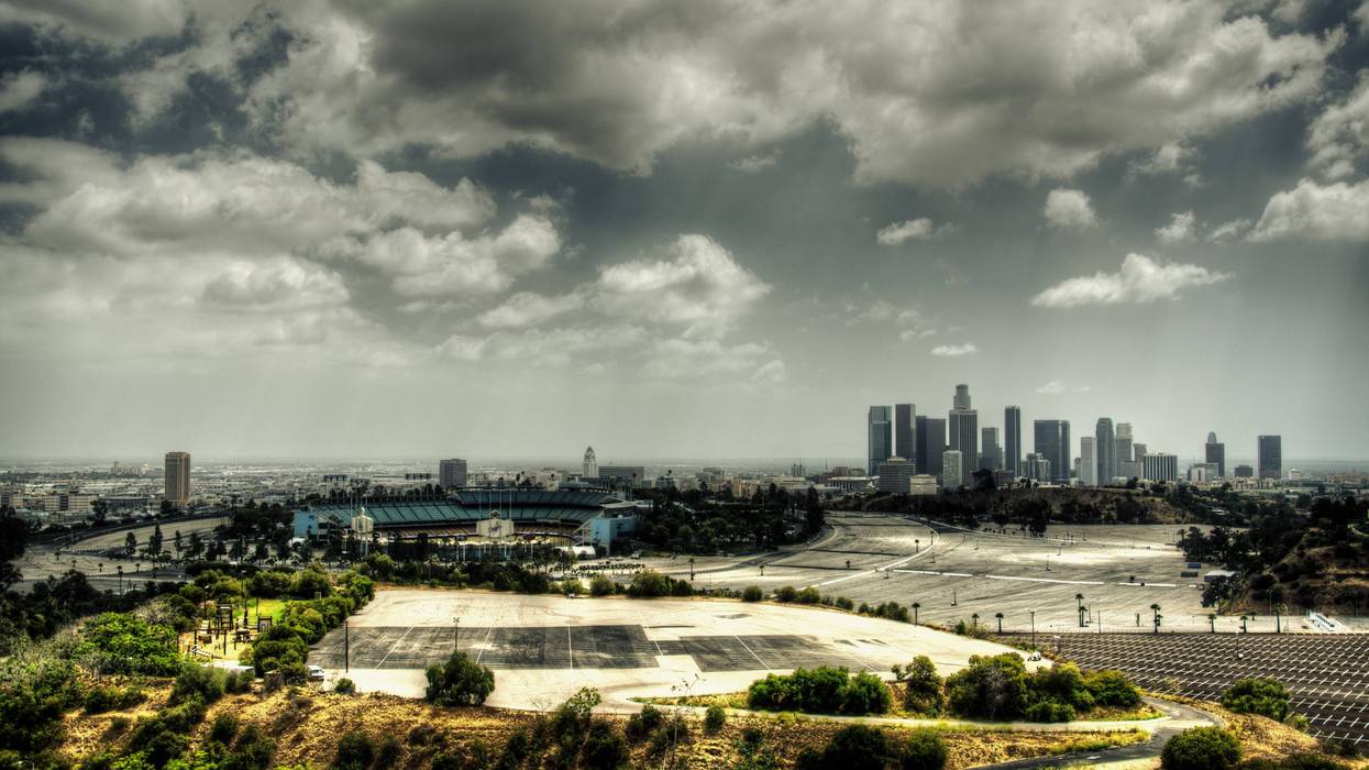 ark clouds hovering over downtown Los Angeles and the Dodger Stadium.