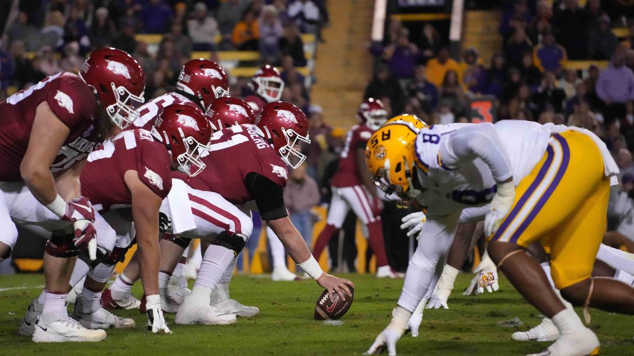 Arkansas Razorbacks offensive lineman Ricky Stromberg (51) snaps the ball at the line of scrimmage against the LSU Tigers at Tiger Stadium