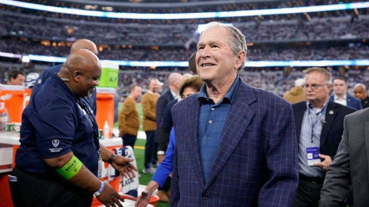 ARLINGTON, TEXAS - NOVEMBER 12: Former president George W. Bush walks the field after the coin toss before the game between the New York Giants and Dallas Cowboys at AT&T Stadium on November 12, 2023 in Arlington, Texas. (Photo by Sam Hodde/Getty Images)