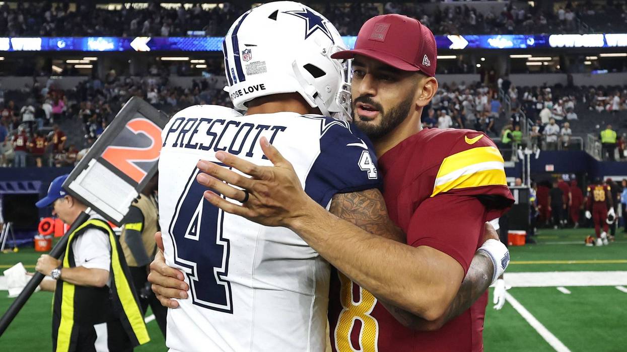 ARLINGTON, TEXAS - OCTOBER 19: Dak Prescott #4 of the Dallas Cowboys and Marcus Mariota #8 of the Washington Commanders hug after Dallas' 44-22 victory at AT&T Stadium on October 19, 2025 in Arlington, Texas. (Photo by Stacy Revere/Getty Images)