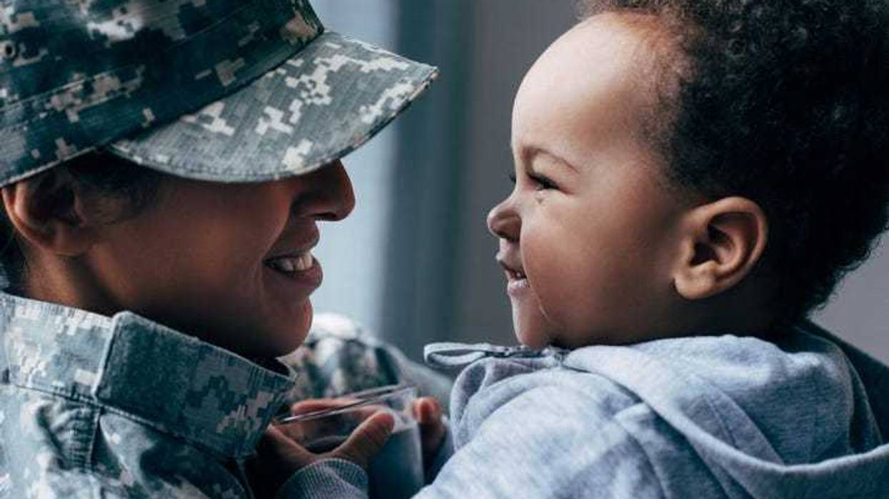 Army mom holding a baby