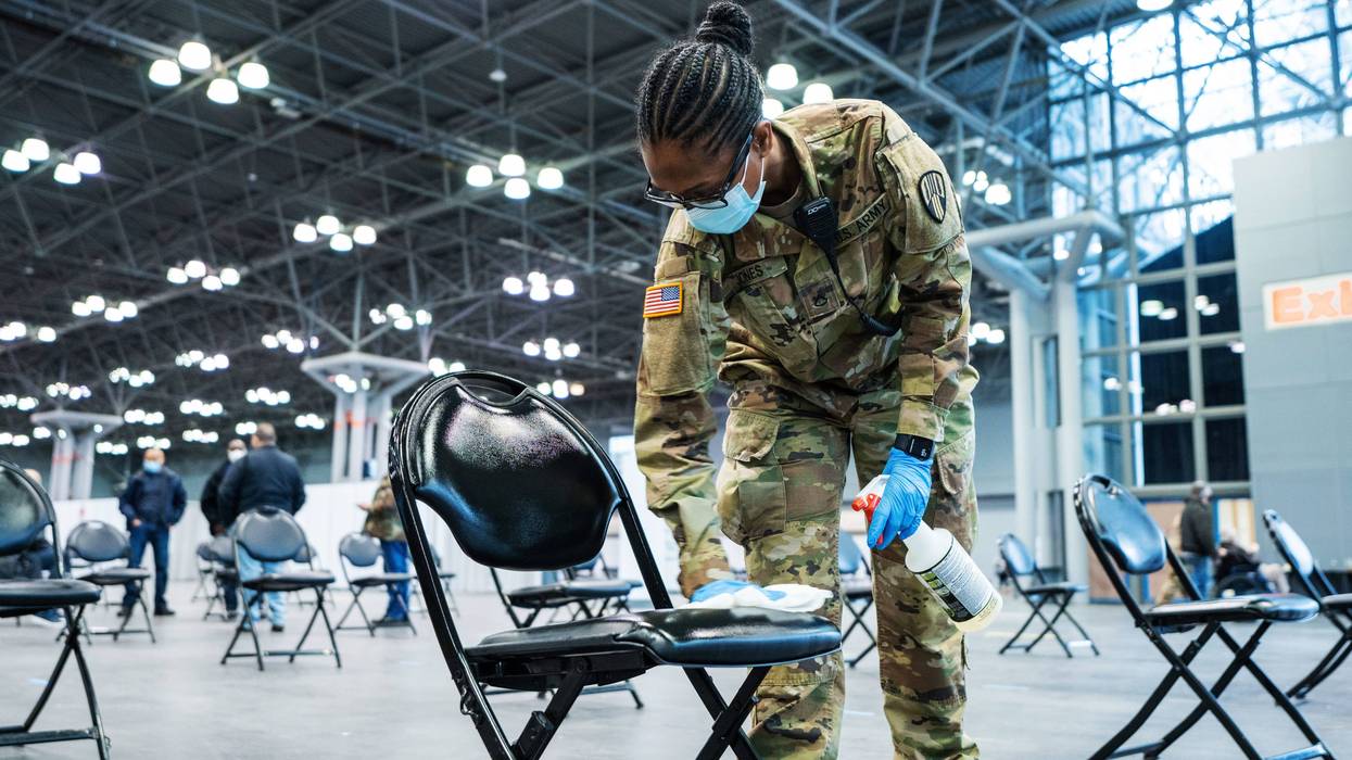 Army Spc. Mary Jones, a motor transport operator, assigned to the 719th Composite Truck Company, 369th Sustainment Brigade, 53rd Troop Command, sanitizes chairs during a mass COVID-19 vaccination event administered by the New York state health department at the Javits Convention Center in New York City, Jan. 31, 2021. The National Guard deployed more than 350 Guardsmen to help staff the vaccination site.