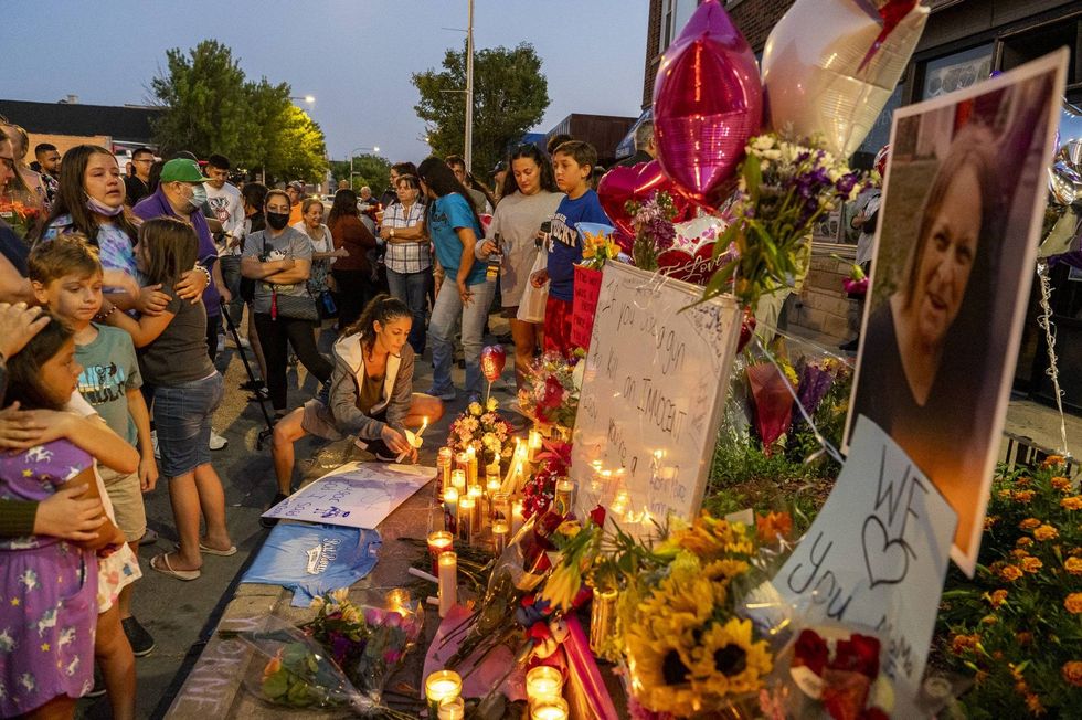 Around 200 family, friends and community members gather for a vigil for Yvonne Ruzich outside Baltimore Food & Liquor Store in the Hegewisch neighborhood, Monday, Aug. 16, 2021. Ruzich was shot and killed earlier this morning in the 13300 block of South Baltimore Ave.