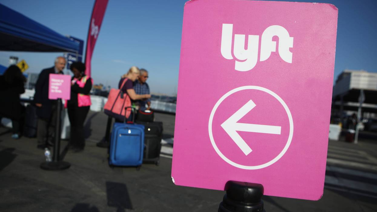 Arriving passengers wait to board Lyft vehicles at the new 'LAX-it' ride-hail passenger pickup lot at Los Angeles International Airport (LAX) on November 6, 2019.