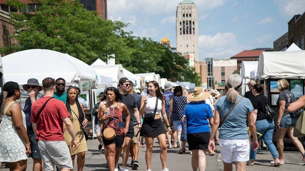 Art lovers walk along South Main Street during the 2022 Ann Arbor Art Fair in Ann Arbor on Thurs., July 21, 2022. The annual Art Fair is held from Thursday to Saturday with nearly 1,000 artists displaying their work over 30 city blocks.