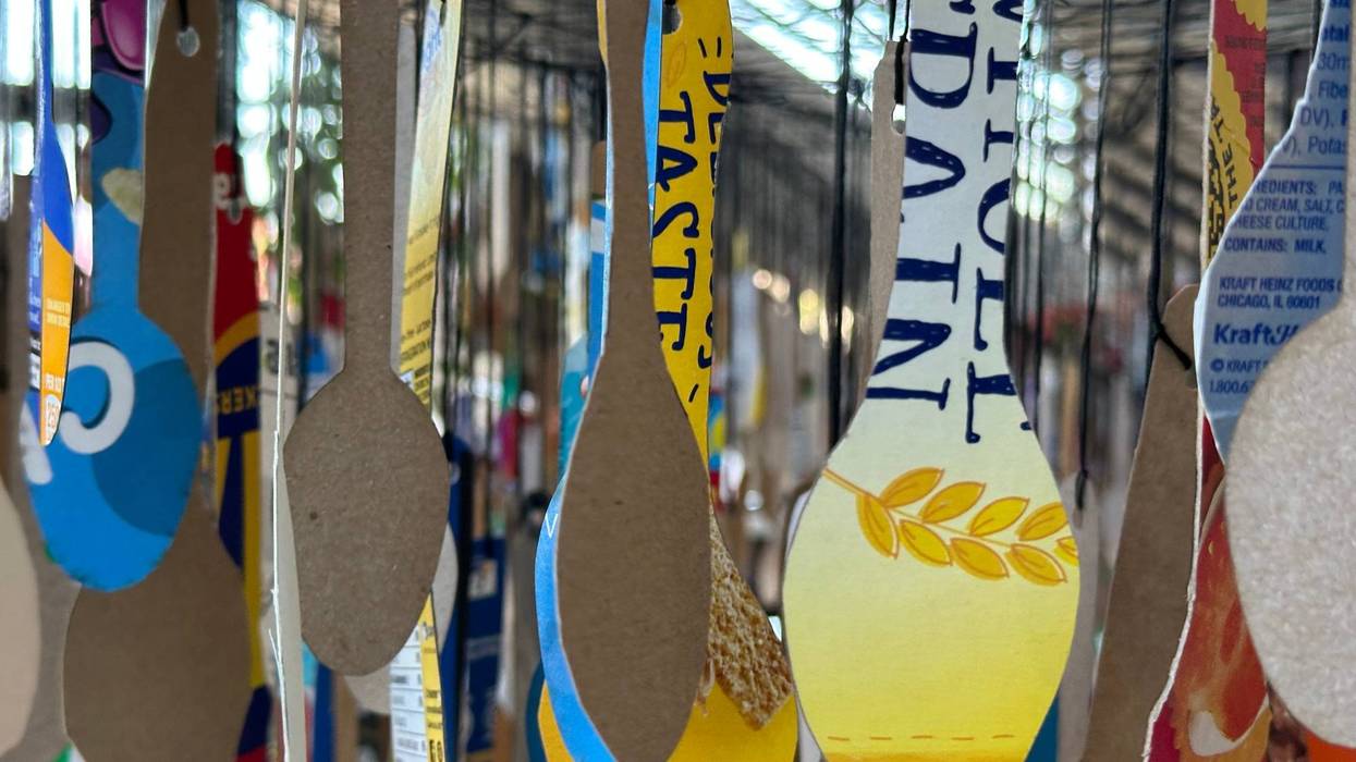 Article 24 art installation, spoons cut from food packaging and individually suspended from netting