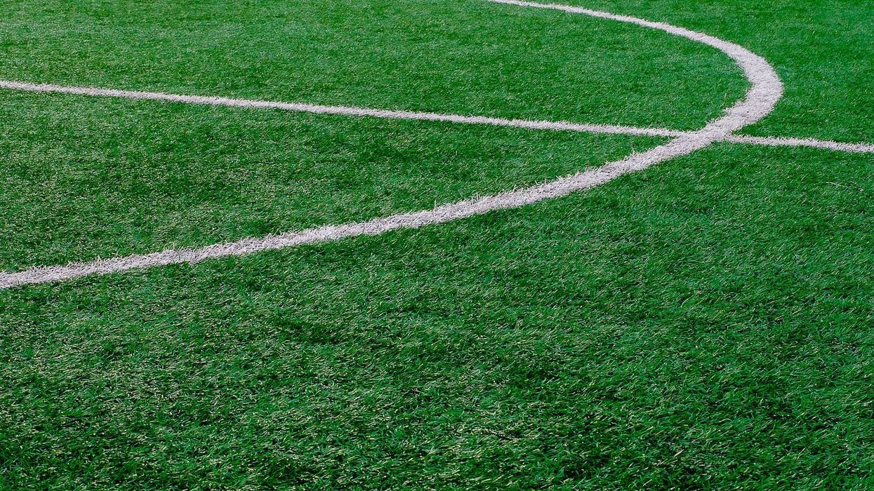 Artificial turf soccer field with center marker line.