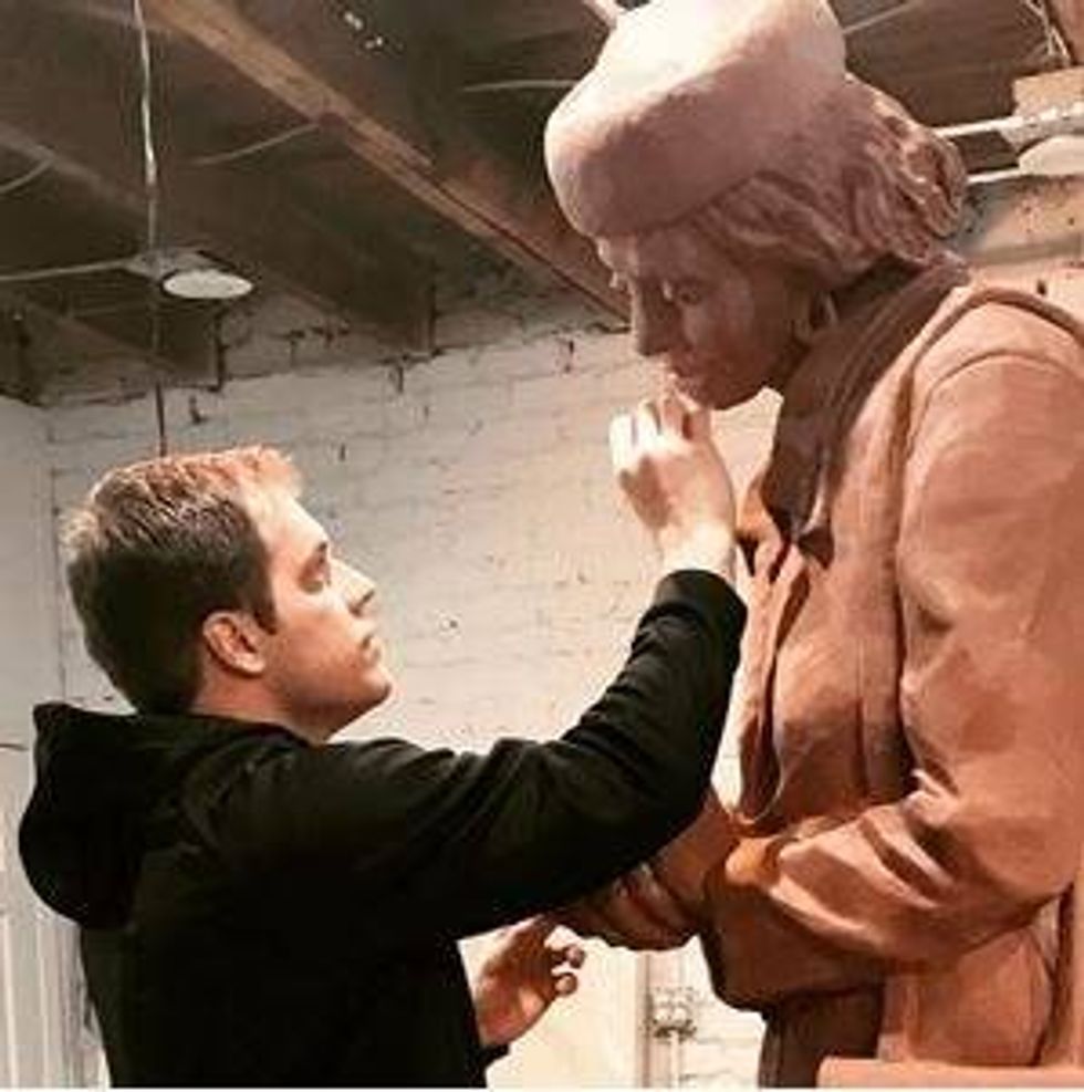 Artist Charlie Pate works on statue of Lila Mae Brock
