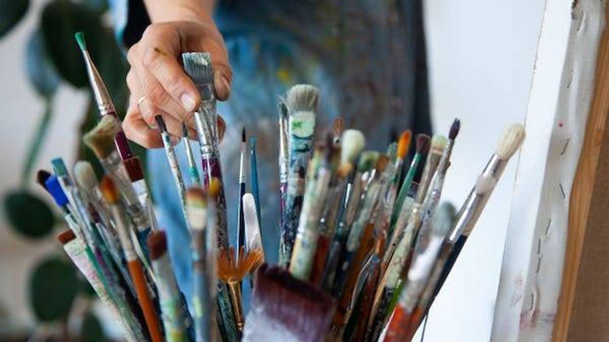 Artist choosing a paintbrush