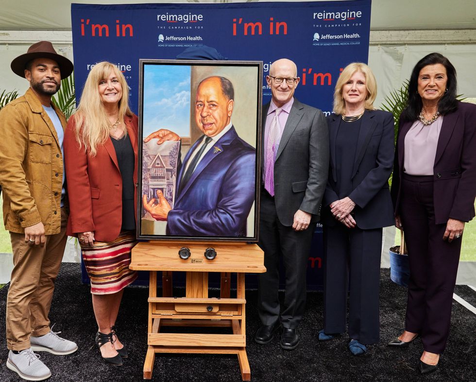 Artist Mario Moore, left, stands with Jefferson Lansdale Hospital administration and his portrait of Dr. Frank E. Boston.