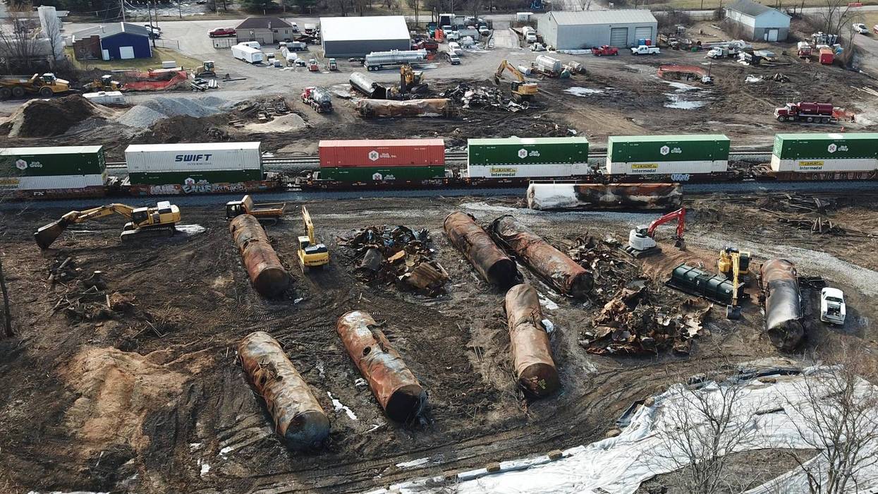 As cleanup continues on Saturday, Feb. 25, 2023, a train rolls past the site of the East Palestine, Ohio