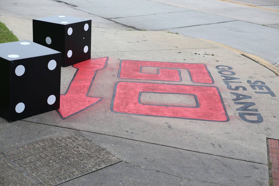 As part of the immersive "game show" experience, the sidewalk leading up to the theater has been painted to look like a Monopoly board.