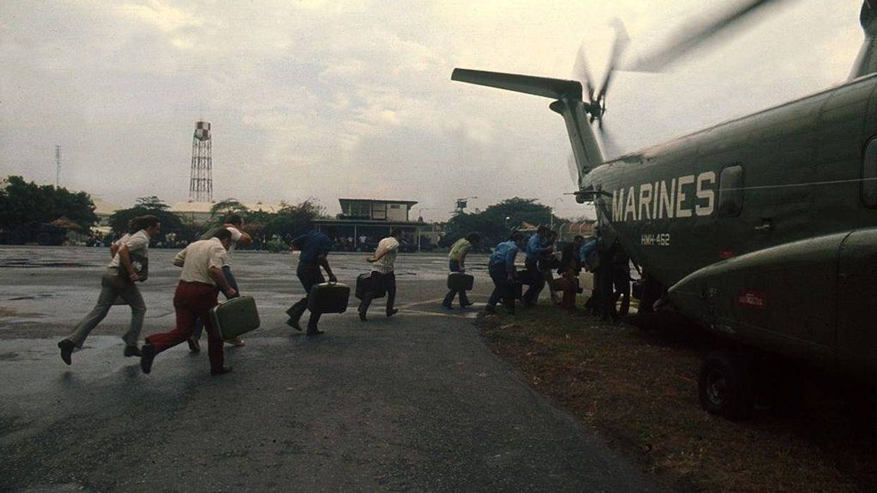 As Saigon falls to the communist rule of North Vietnamese, US Marines evacuate Americans and Vietnamese April, 1975 at Tan Son Nhut Airbase, in South Vietnam