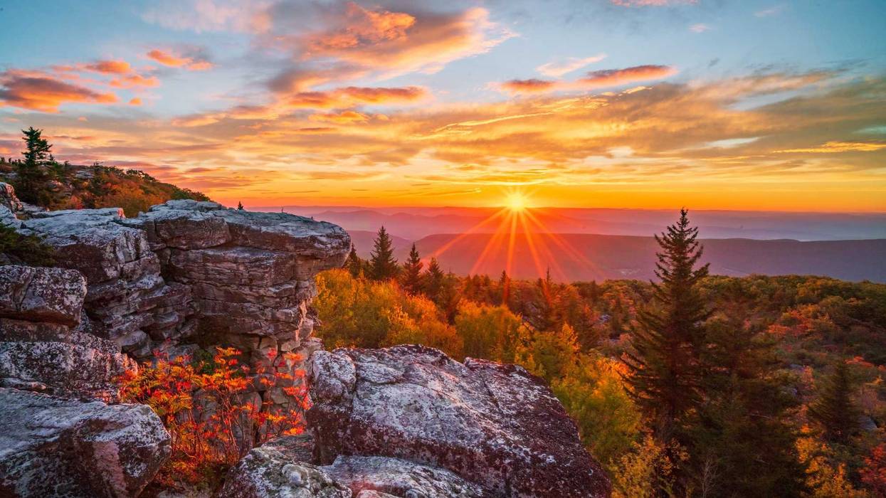 As viewed from the Bear Rocks area of the Dolly Sods Wilderness, the sun rises over a mountain ridge in the highlands of West Virginia.