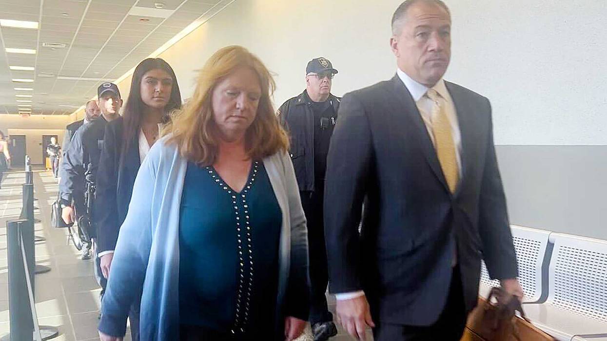 Asa Ellerup, estranged wife of Gilgo Beach suspect Rex Heuermann, walks into the courtroom in Riverhead, New York, with her lawyer, Bob Macedonio, on Nov. 15, 2023