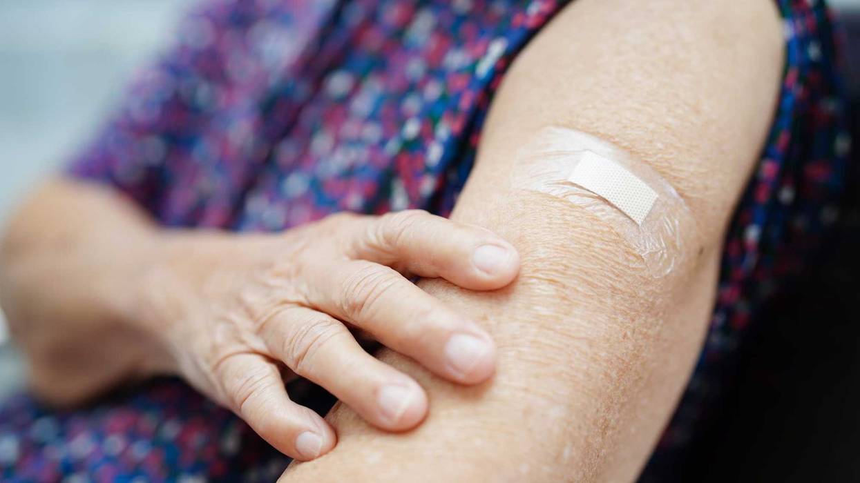 Asian elder senior woman patient getting coronavirus vaccine.