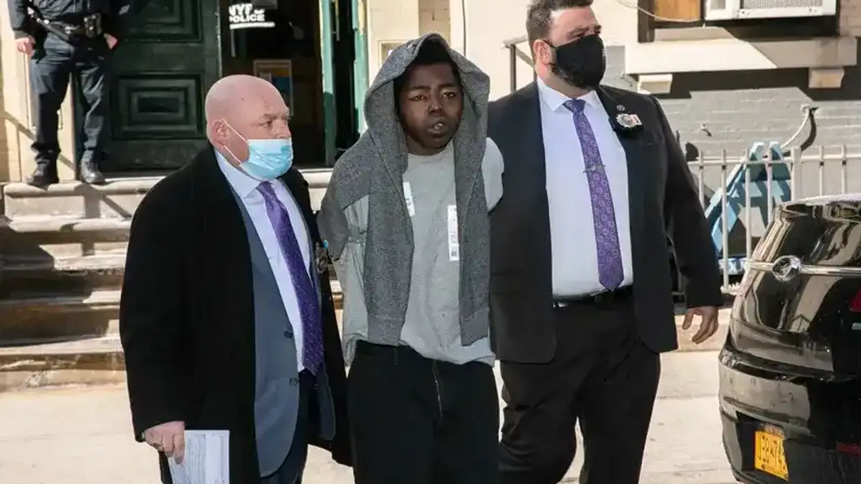 Assamad Nash, center, is escorted by police officers from the 5th Precinct in Manhattan on Feb. 14, 2022.