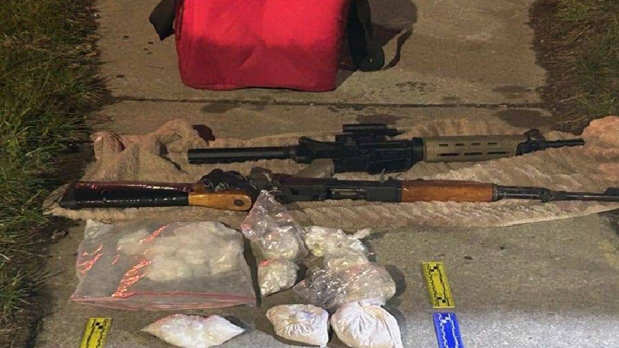 Assault rifles, bags of drugs seized in raid