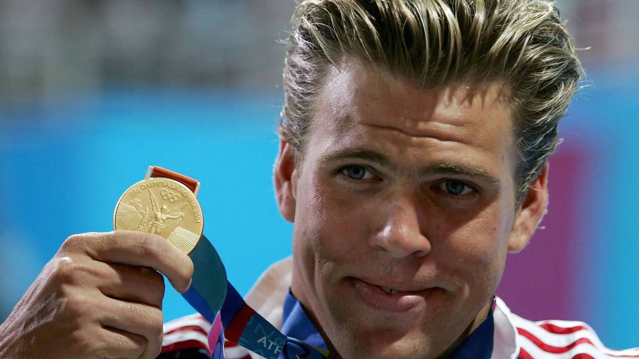 ATHENS - AUGUST 20: Gary Hall Jr. of the United States shows off his gold medal for the men's swimming 50 metre freestyle event on August 20, 2004 during the Athens 2004 Summer Olympic Games at the Main Pool of the Olympic Sports Complex Aquatic Centre in Athens, Greece.