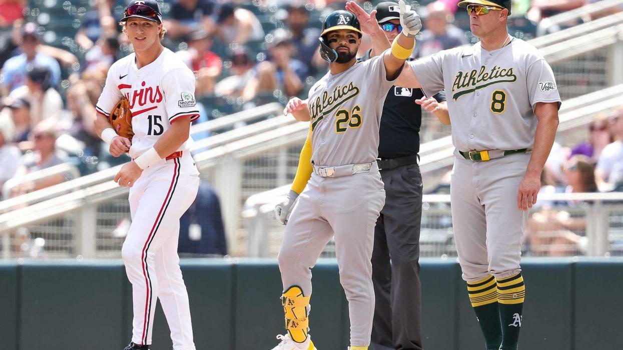 Athletics right fielder Carlos Cortes (26) celebrates his RBI single against the Minnesota Twins during the second inning at Target Field during the A's 8-3 Thursday.