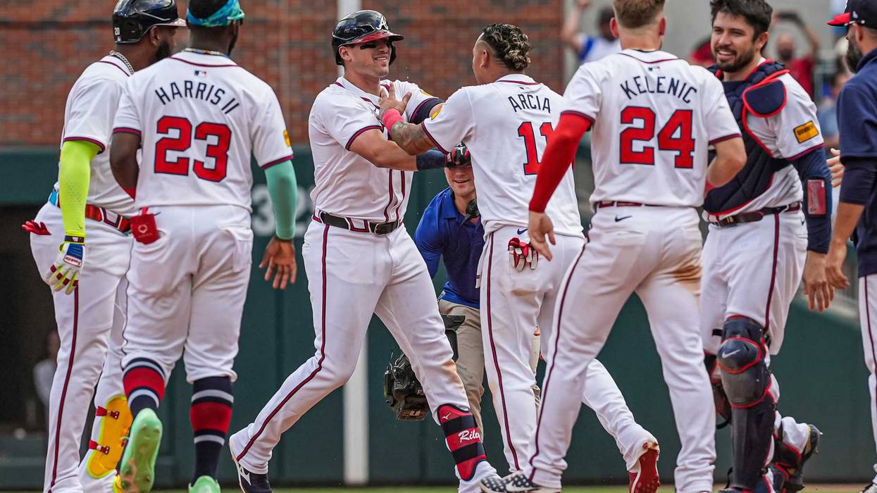 Atlanta Braves 3B Austin Riley reacts with SS Orlando Arcia after hitting the game winning single against the Cleveland Guardians