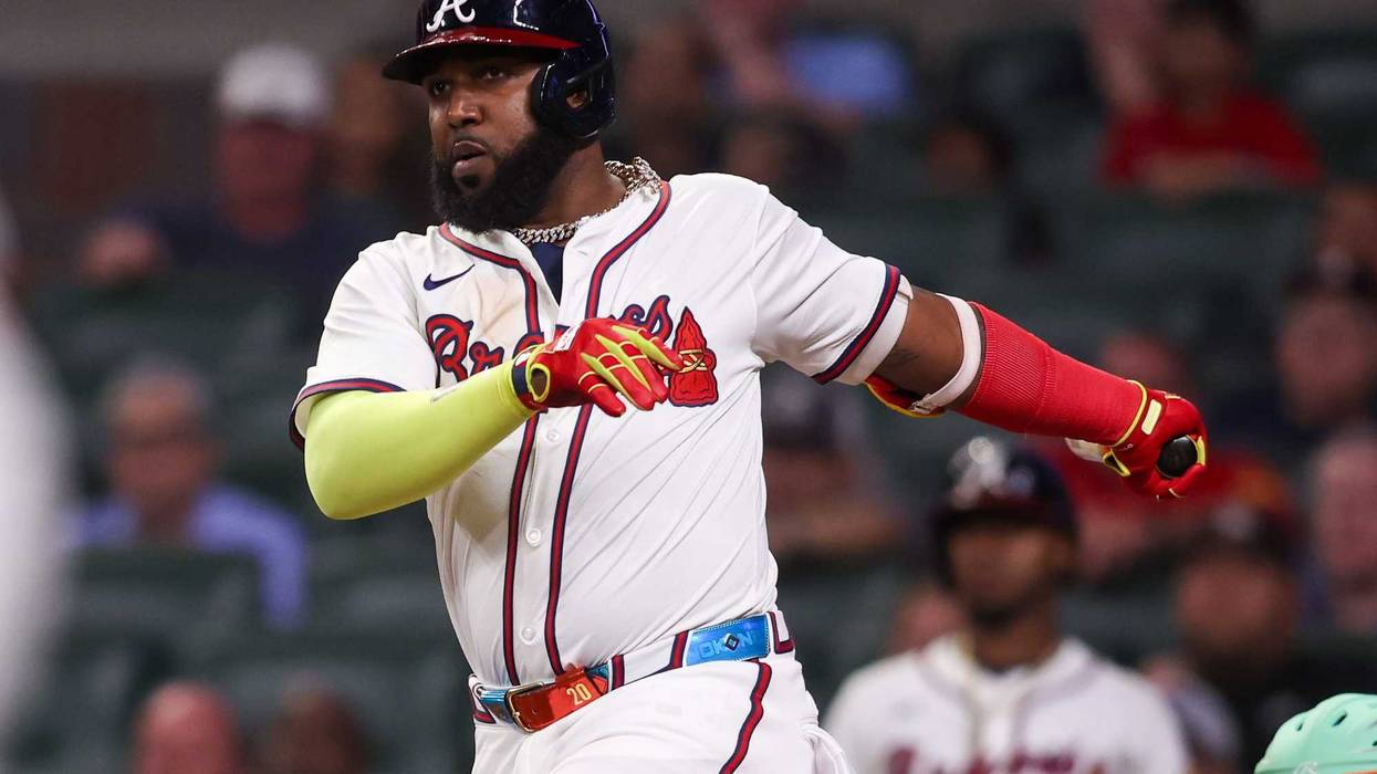 Atlanta Braves designated hitter Marcell Ozuna (20) hits an RBI double against the New York Mets in the eighth inning at Truist Park.