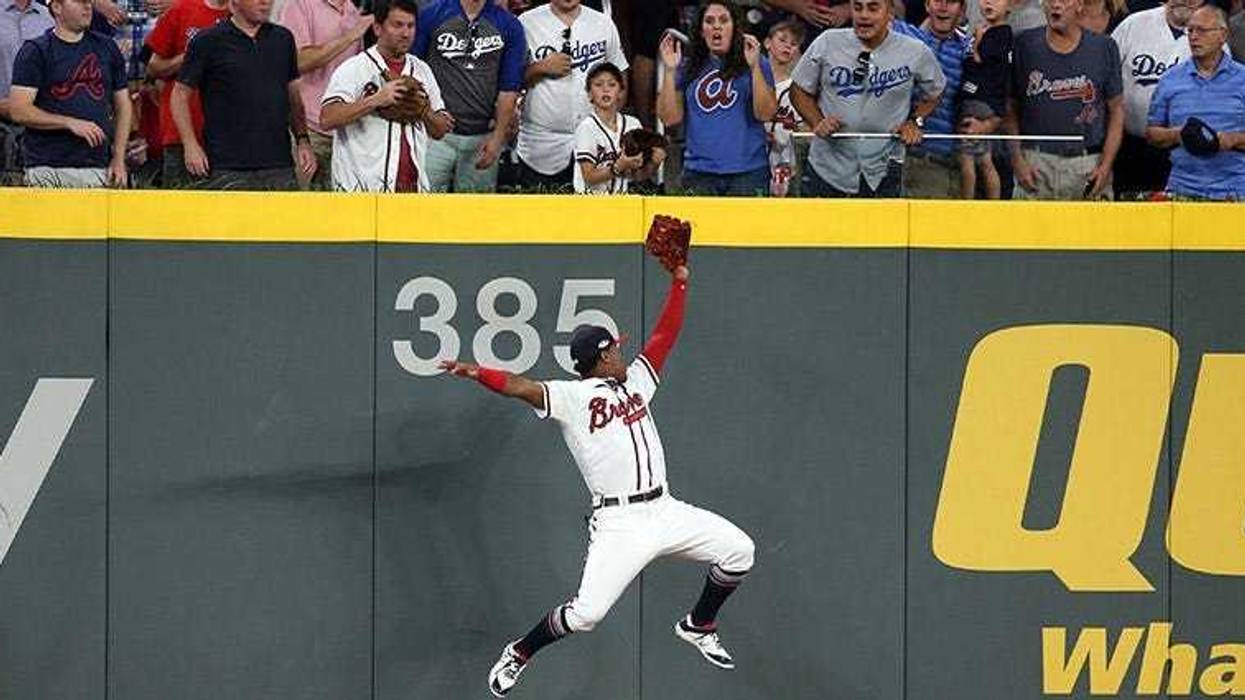 Atlanta Braves left fielder Ronald Acuna Jr. makes a catch at the wall