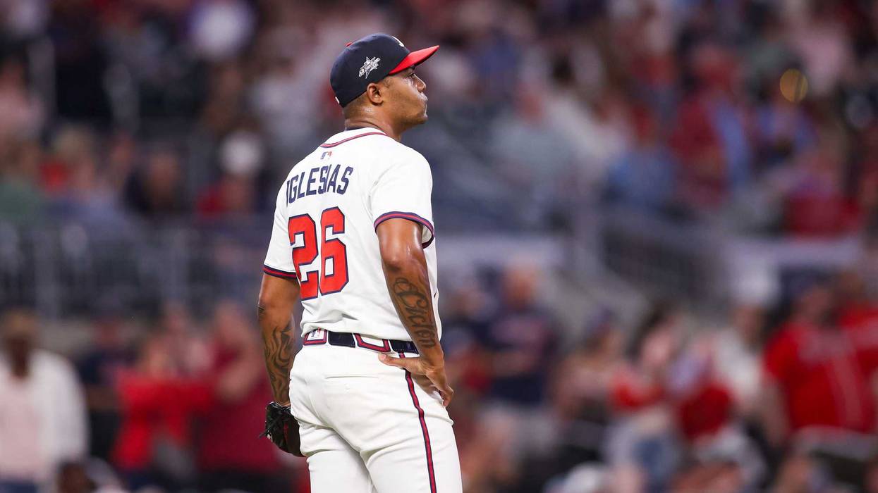 Atlanta Braves relief pitcher Raisel Iglesias (26) reacts after giving up a home run against the St. Louis Cardinals in the ninth inning at Truist Park.