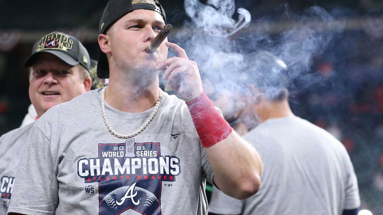 Atlanta Braves right fielder Joc Pederson smokes a cigar after defeating the Houston Astros in game six of the 2021 World Series at Minute Maid Park.