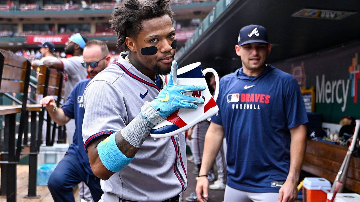 Atlanta Braves right fielder Ronald Acuna Jr (13) celebrates in the dugout after hitting a solo home run against the St. Louis Cardinals during the first inning at Busch Stadium