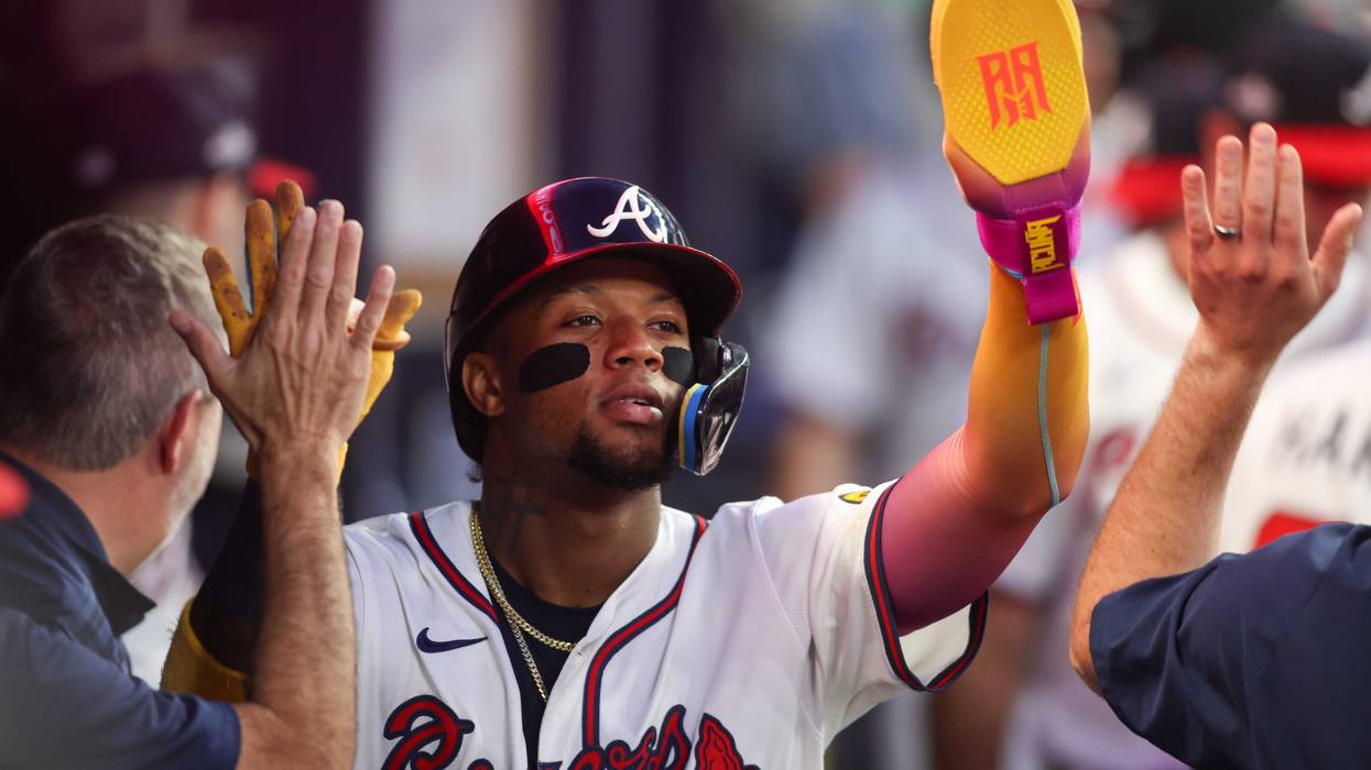 Atlanta Braves right fielder Ronald Acuna Jr. (13) celebrates with teammates after scoring a run against the New York Mets in the fifth inning at Truist Park.