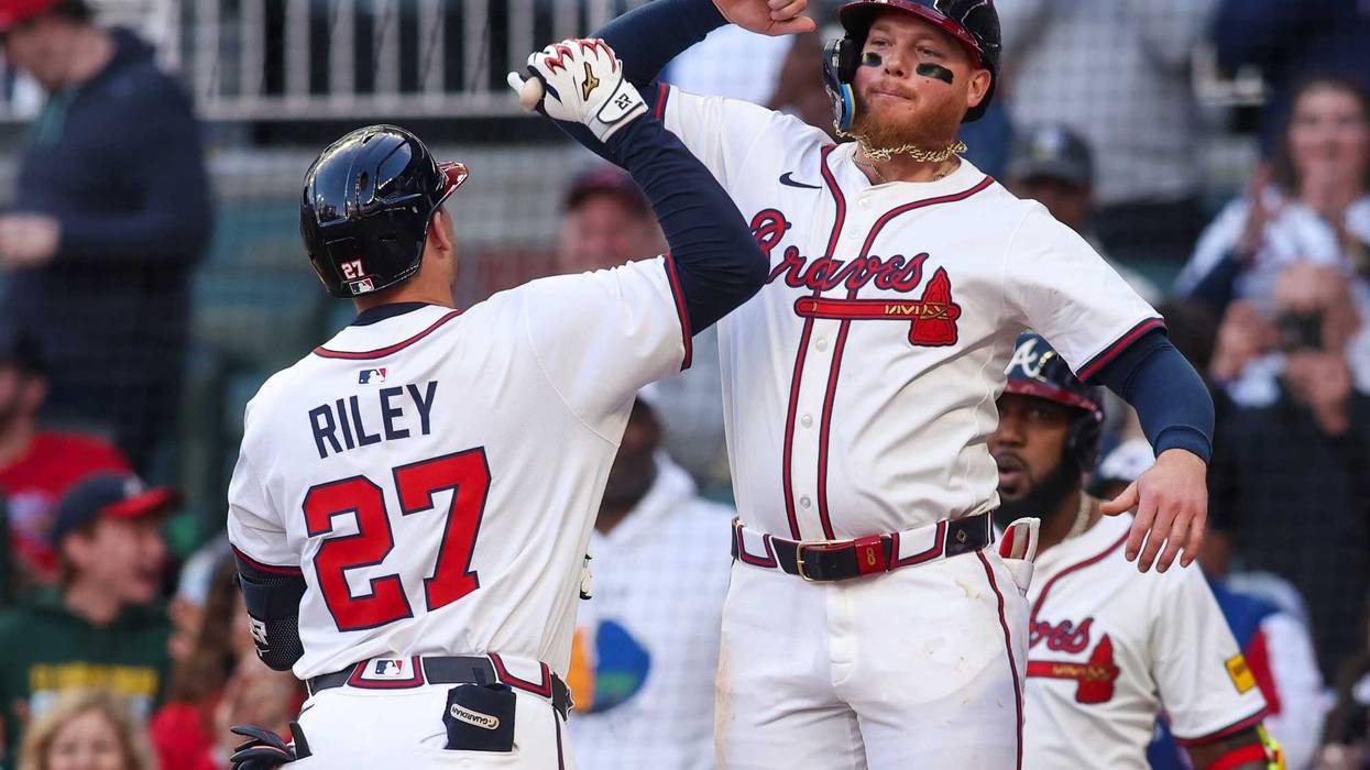 Atlanta Braves third baseman Austin Riley (27) celebrates with left fielder Alex Verdugo (8) after a two-run home run against the Los Angeles Dodgers in the third inning at Truist Park.