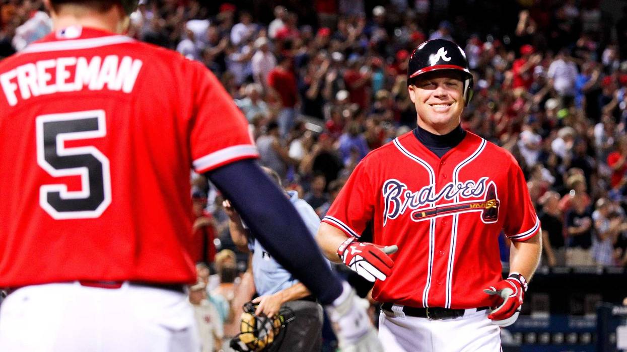 Atlanta Braves third baseman Chipper Jones (10) celebrates with first baseman Freddie Freeman (5)