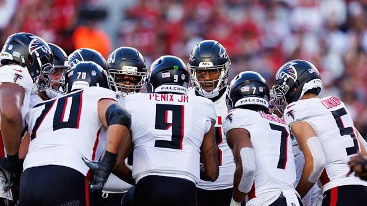 Atlanta Falcons players in a huddle