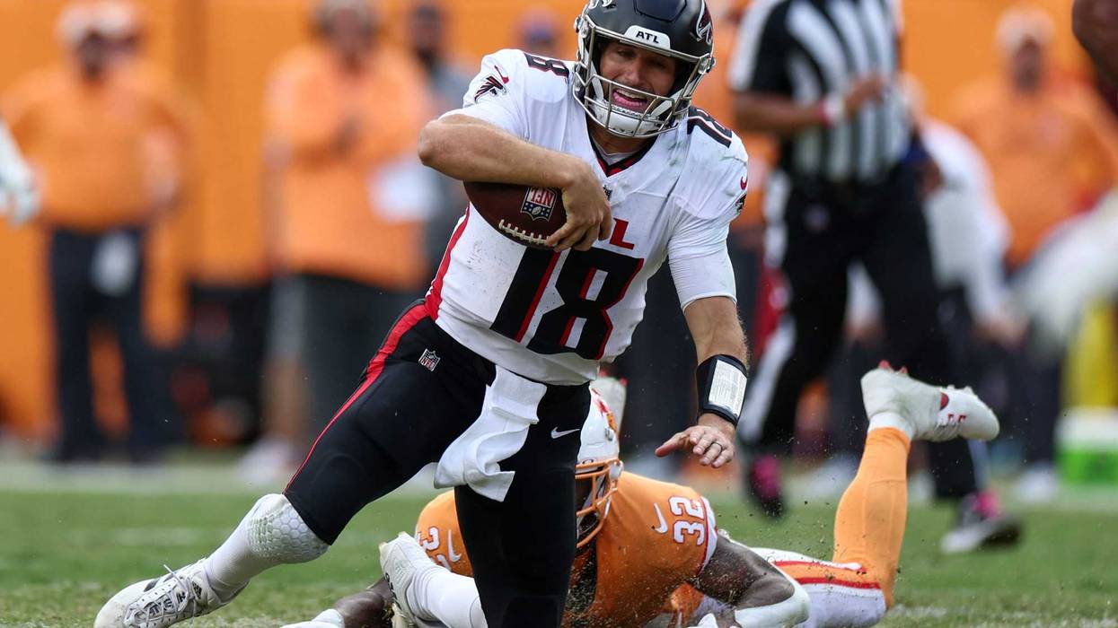 Atlanta Falcons quarterback Kirk Cousins (18) is brought down by Tampa Bay Buccaneers safety Josh Hayes (32) in the fourth quarter at Raymond James Stadium.