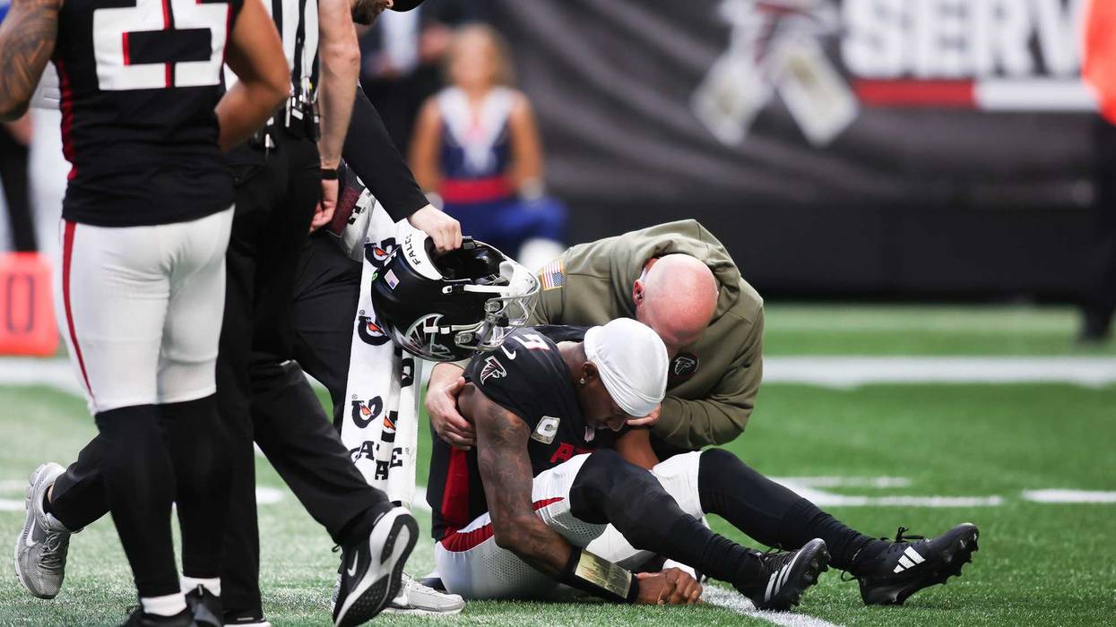 Atlanta Falcons quarterback Michael Penix Jr. (9) is attended to by medical staff in the third quarter against the Carolina Panthers at Mercedes-Benz Stadium.