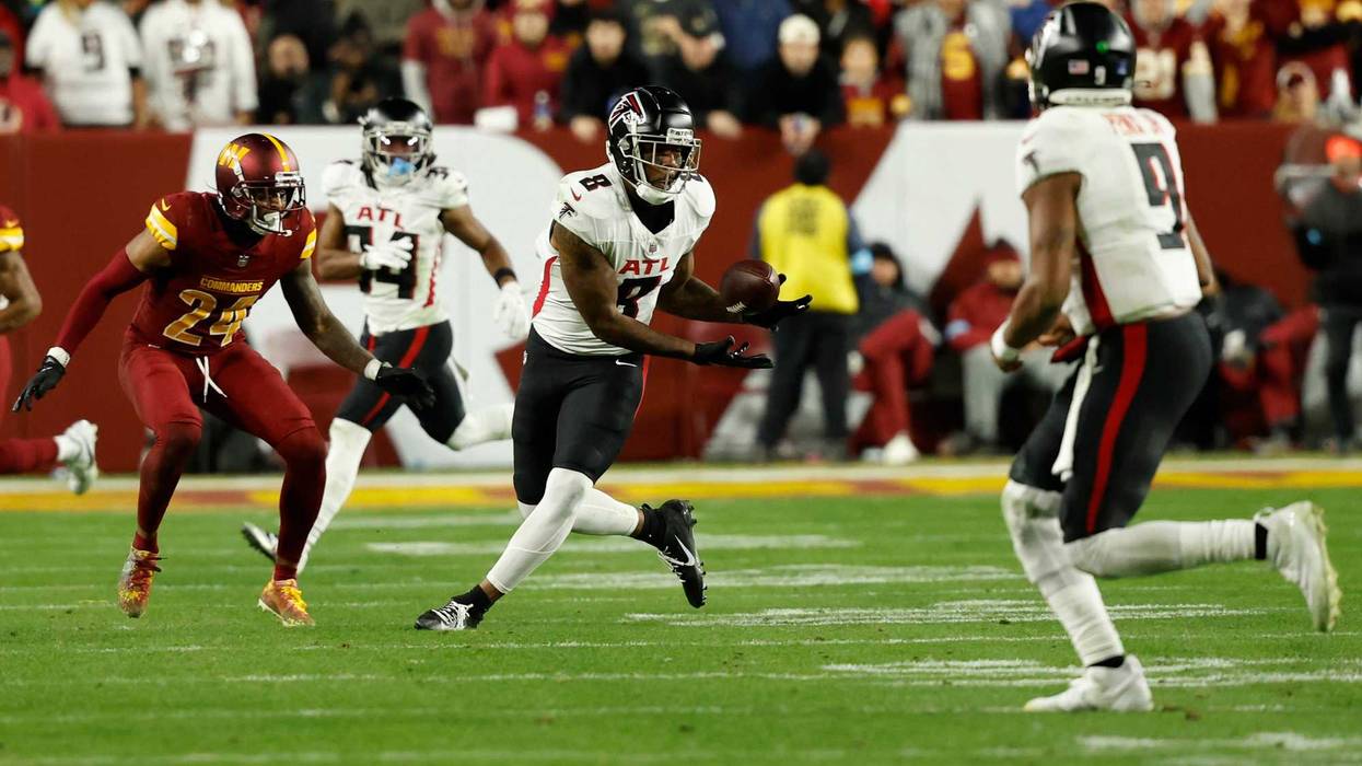Atlanta Falcons tight end Kyle Pitts (8) catches a pass from Falcons quarterback Michael Penix Jr. (9) as Washington Commanders cornerback Michael Davis (24) defends during the fourth quarter at Northwest Stadium