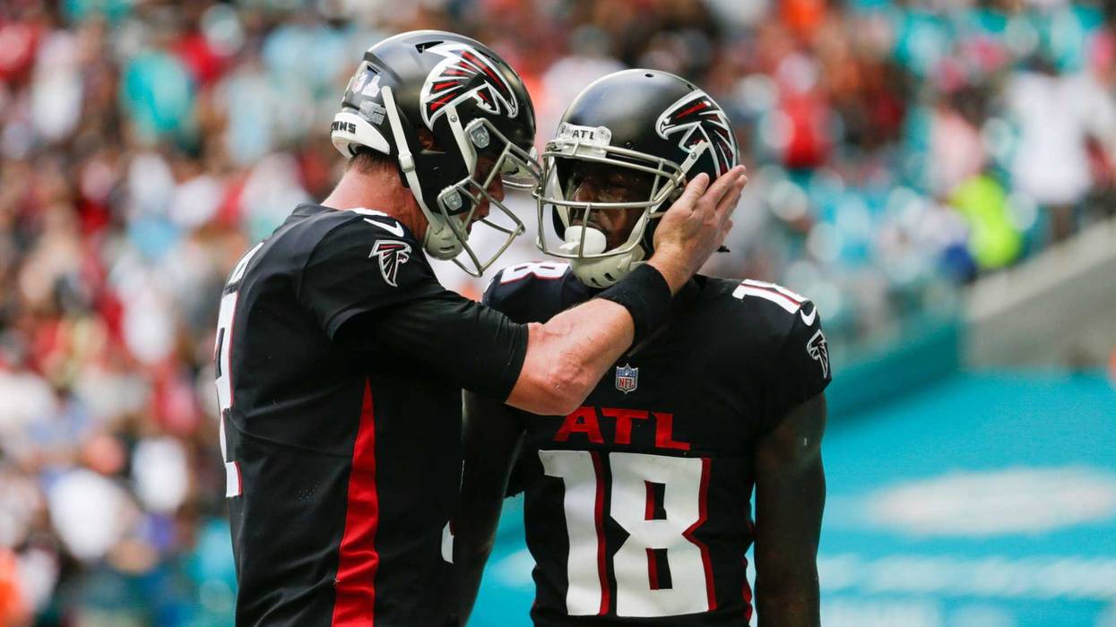 Atlanta Falcons wide receiver Calvin Ridley (18) gets a tap on the helmet from quarterback Matt Ryan (2) after scoring a touchdown